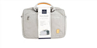 Light gray laptop bag with included product tag card clipped to the front zip pocket