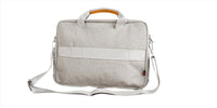 Light gray laptop bag side profile with adjustable strap and stitched seam panel