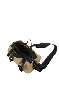Waterproof shoulder bag with tan body and black zipper compartment, side view