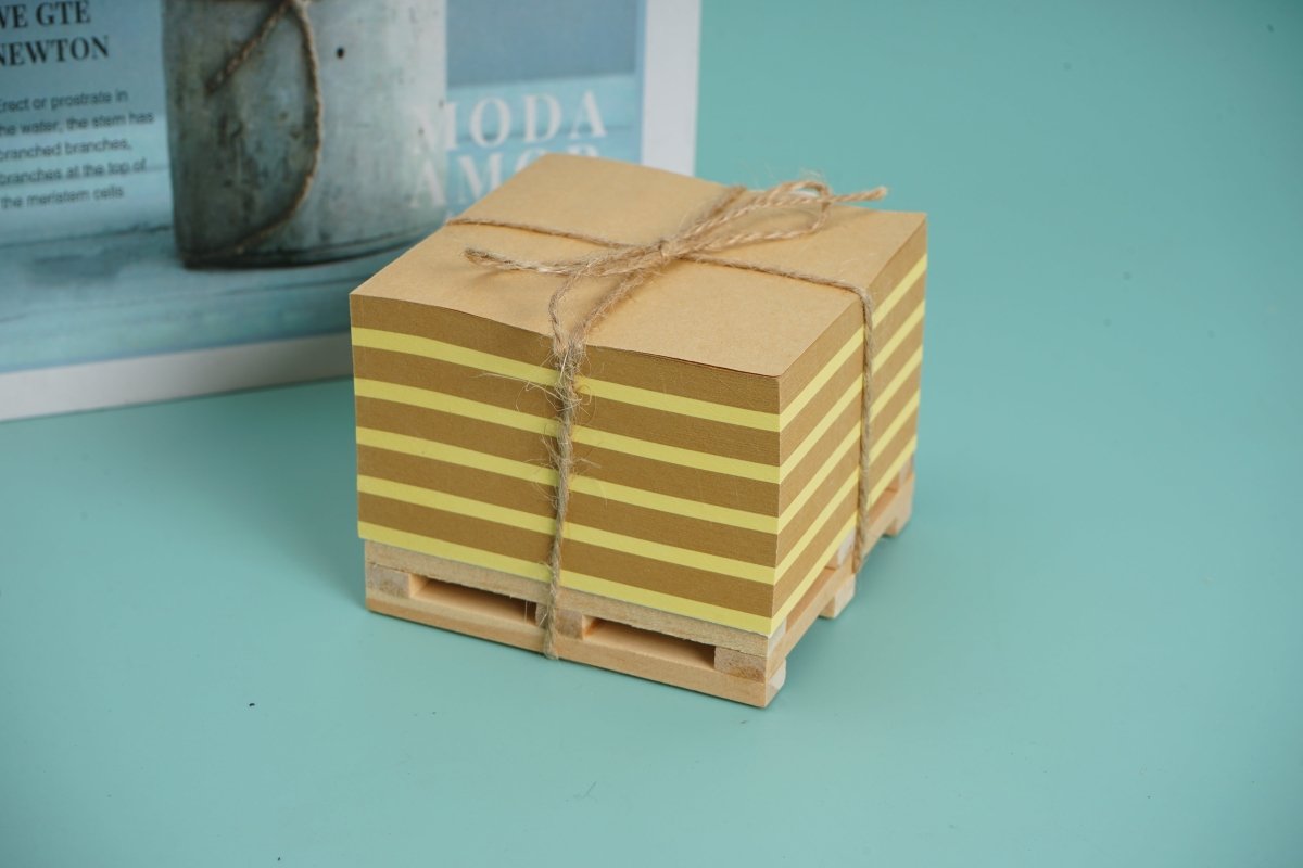 Square wooden memo pad with twine-tied stacked notes on a small wooden tray