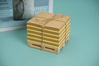 Square wooden memo pad with twine-tied stacked notes on a small wooden tray