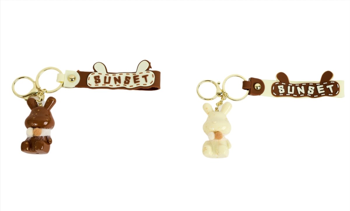 Rabbit keychain pair with key rings; brown and beige bunnies and 'SUNSET' straps