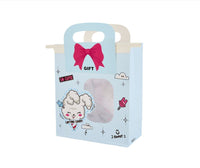 Light blue gift bag with cotton candy cloud illustration and pink bow handle