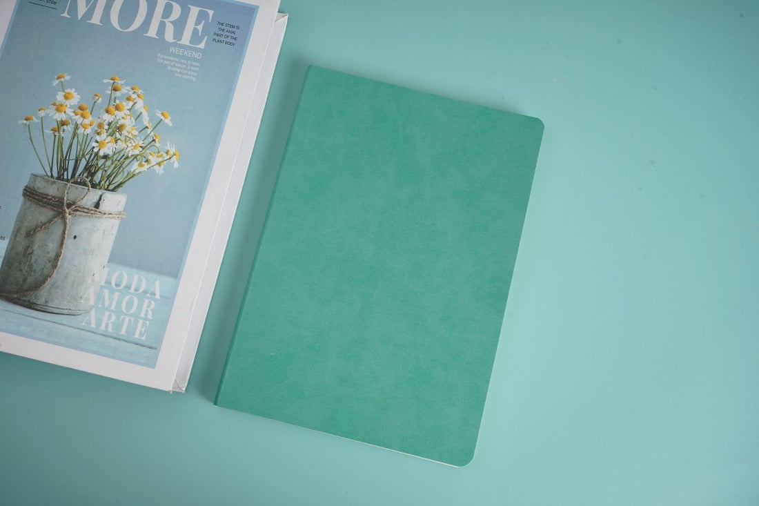 Teal ruled notebook, rounded corners, closed.