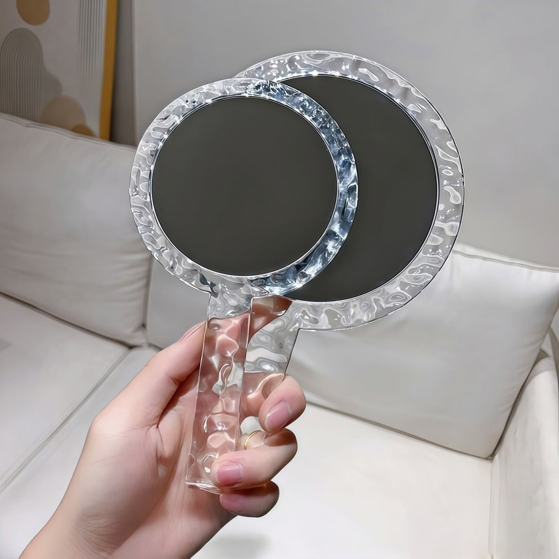 Transparent handheld mirror with ripple-textured round frame and clear grip