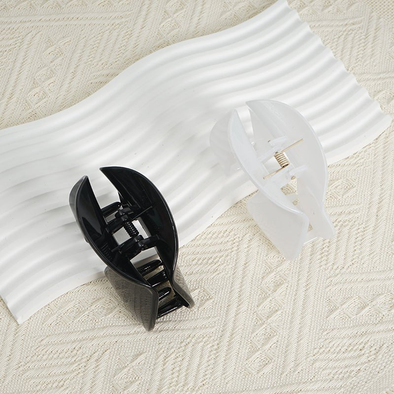 Assorted plastic hair clips in black and white with pronged design