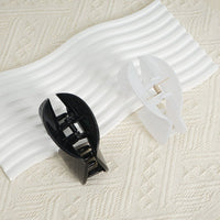 Assorted plastic hair clips in black and white with pronged design