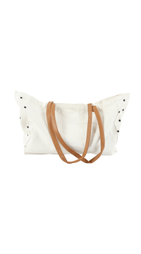 White tote bag with black polka dots and brown handles, open top view