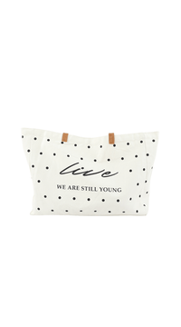 White tote bag with black polka dots, brown handles, front logo text