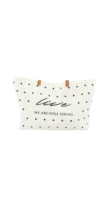 White tote bag with black polka dots, brown handles, front logo text