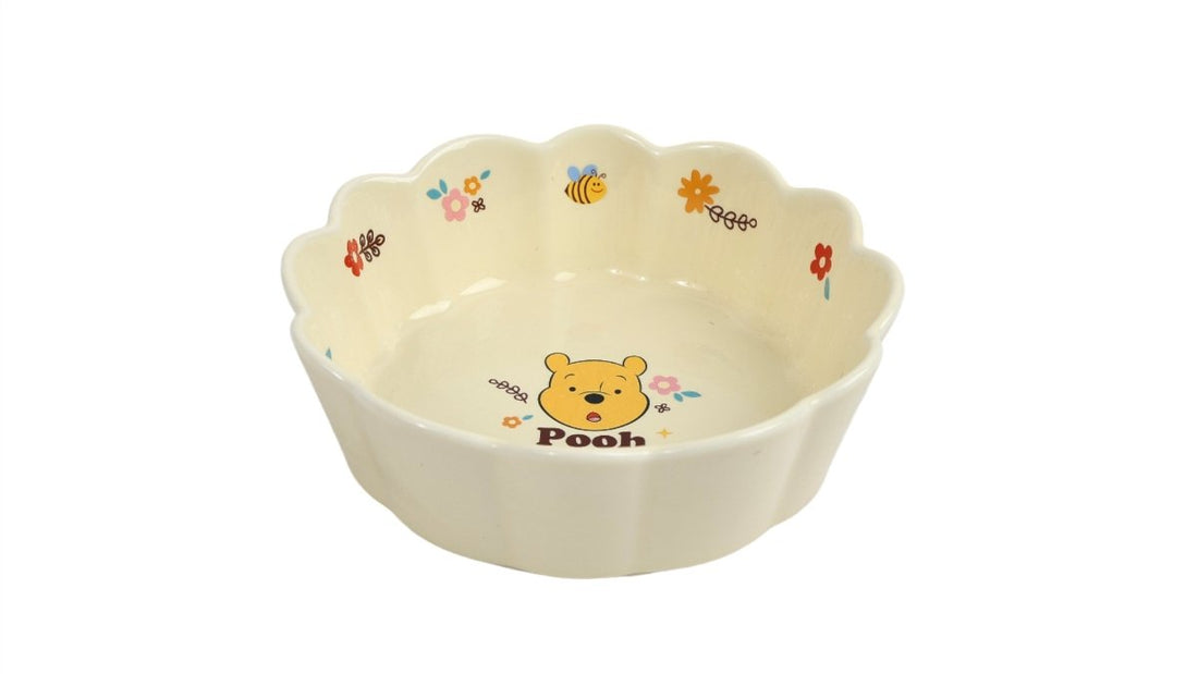 Winnie the Pooh ceramic bowl with scalloped edges and Pooh face illustration