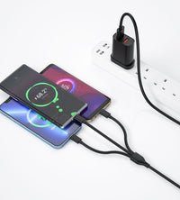 Black dual-port UK charger with 3-in-1 cable charging a smartphone