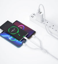 White dual-port UK charger with 3-in-1 cable charging a smartphone