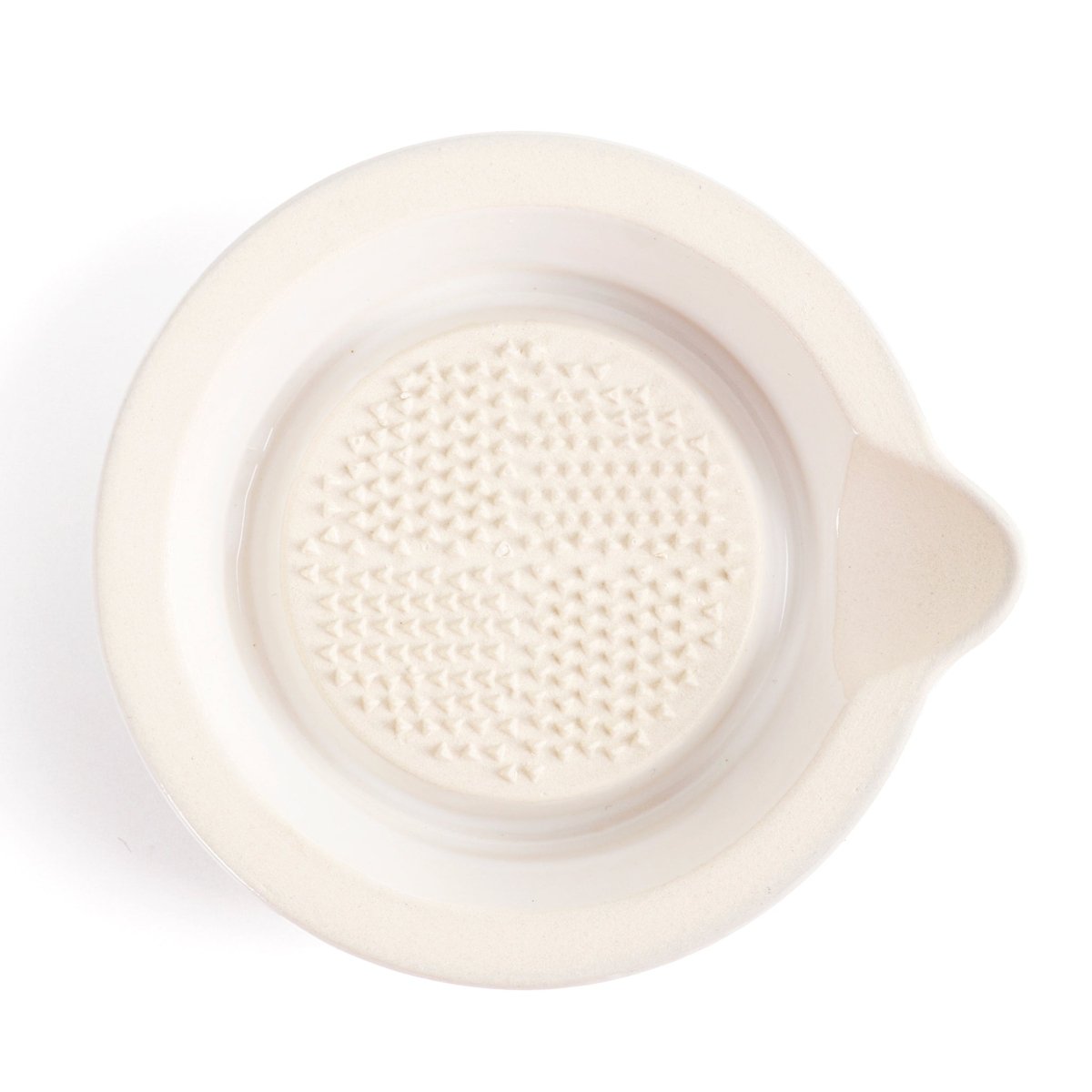 Close-up of ceramic spoon rest with textured insert, light cream