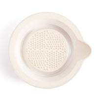 Close-up of ceramic spoon rest with textured insert, light cream