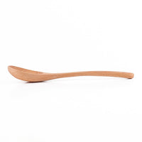 Wooden spoon with elongated bowl and smooth handle, light wood finish