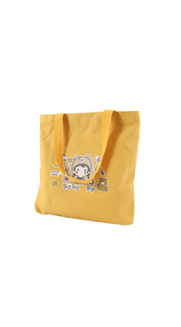 Yellow cartoon tote bag with bear character graphic and carry handles